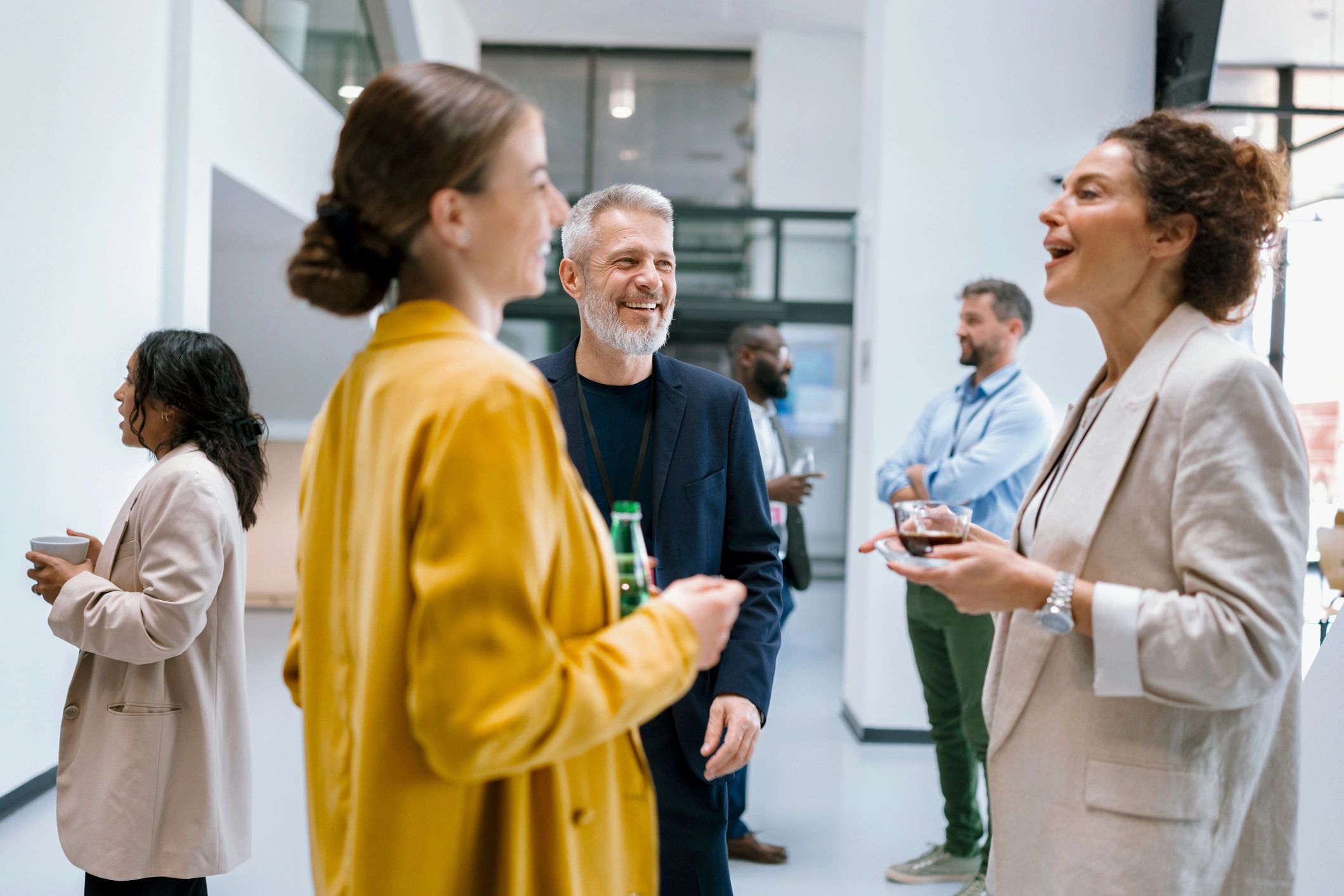 Colleagues networking over coffee during a conference break