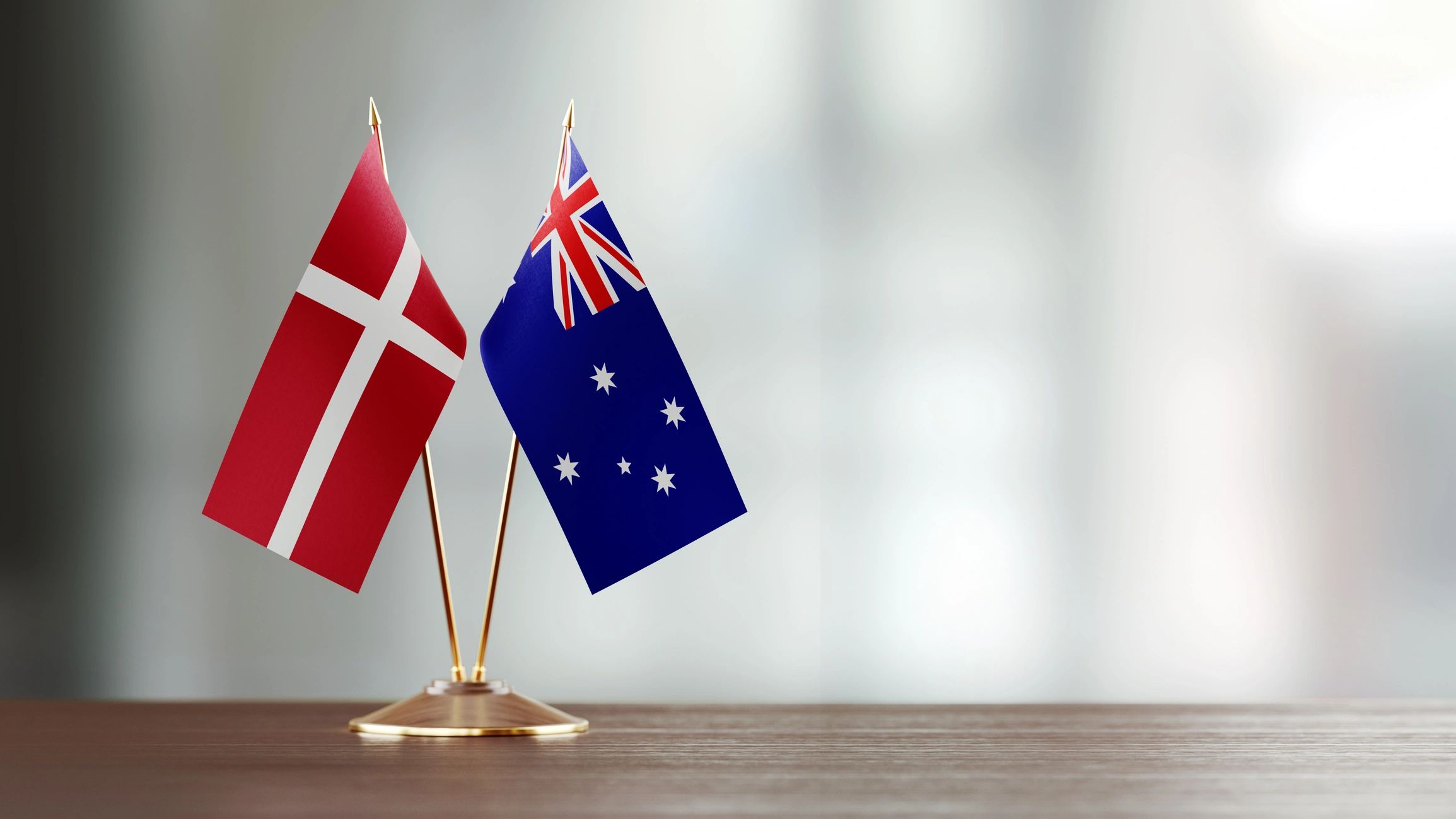 Denmark and Australia flags on a desk for a chamber event